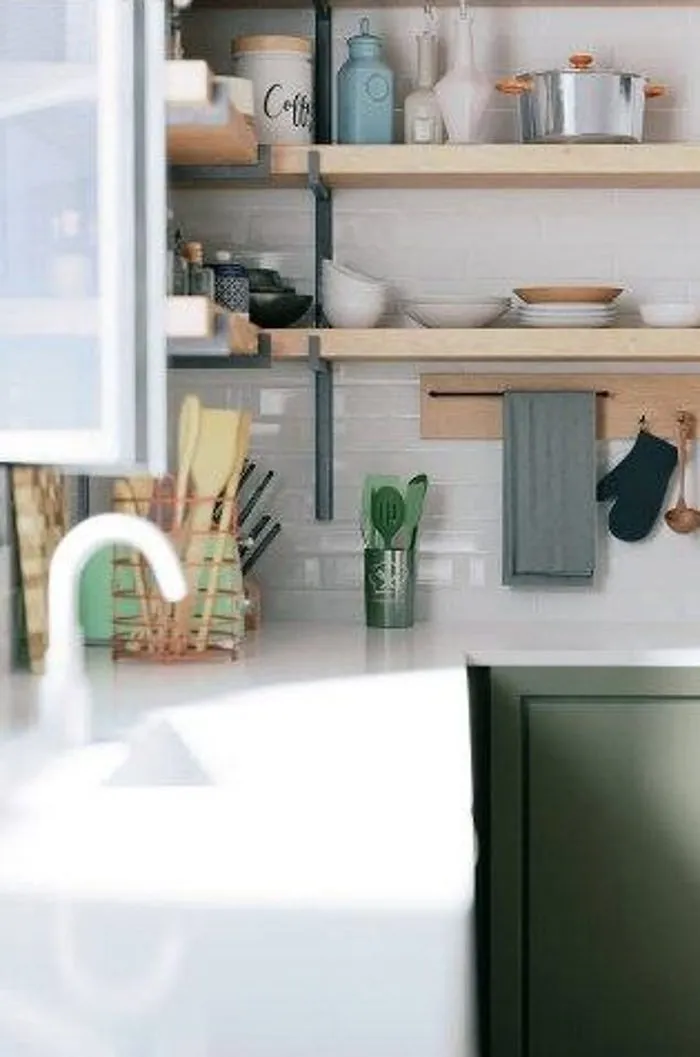 Open timber shelves above sage cabinets in a kitchen render